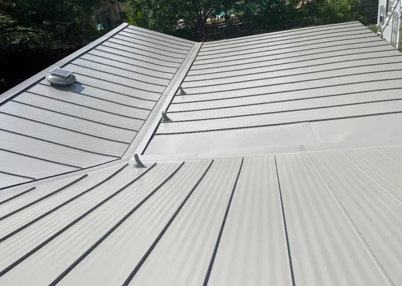 Solar attic fan installed on a metal roof for Roof Ventilation in Groesbeck